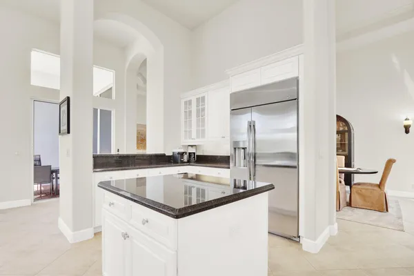a view of a dining room with furniture a chandelier and wooden floor