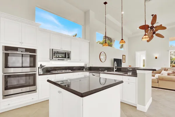 a living room with furniture a flat screen tv and a window