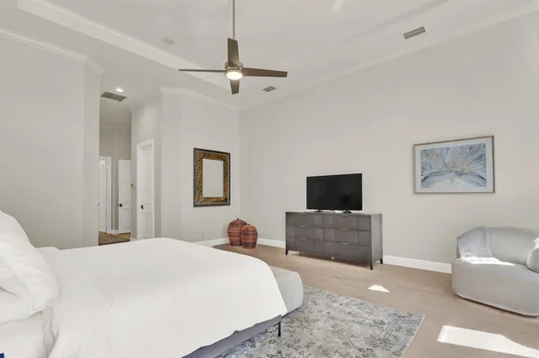 a bedroom with a bed and a chandelier
