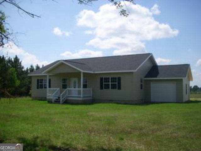 711 Jerry Talley Road Lyons, GA 30436 - Photo 1 of 1 a front view of house with yard and green space