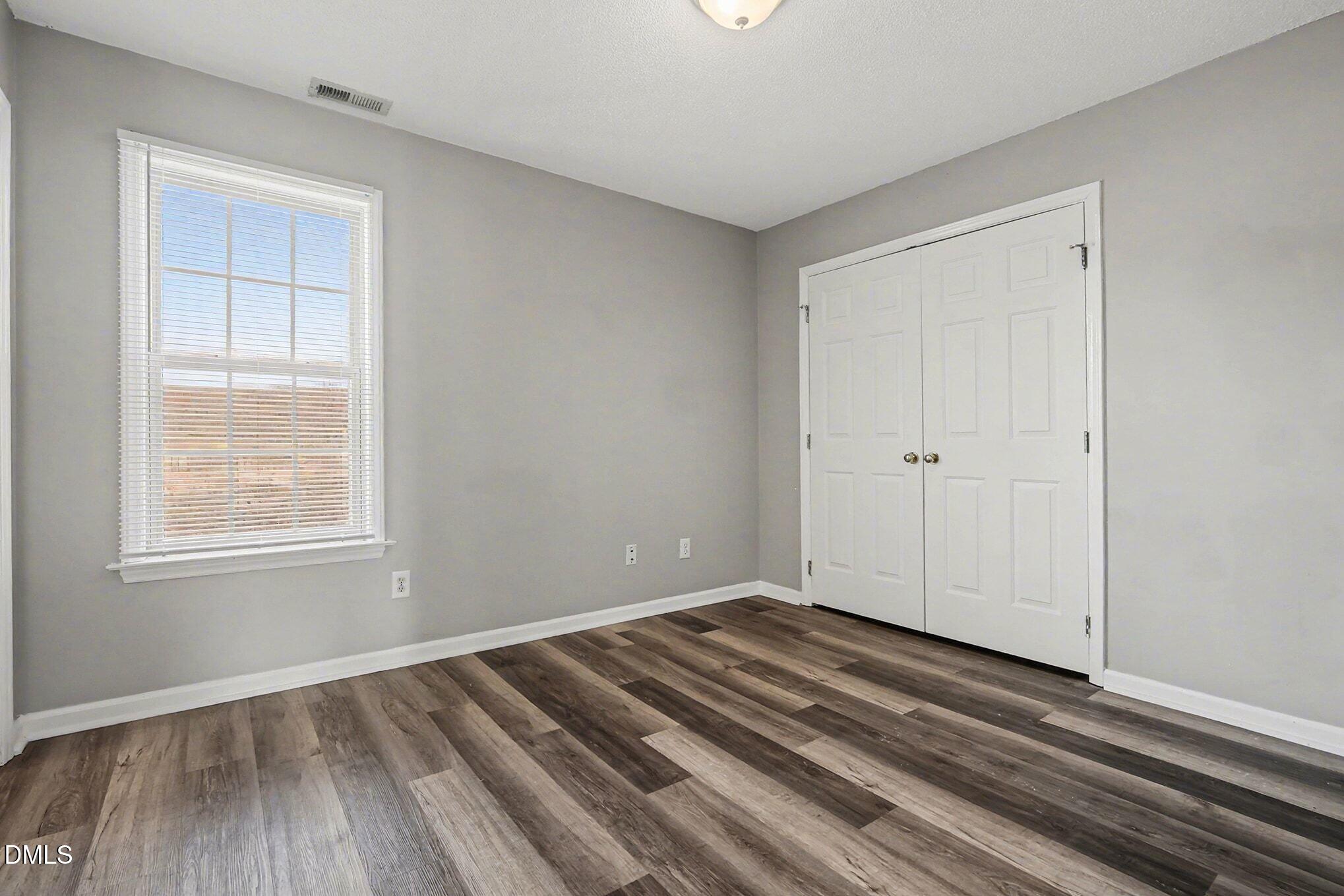 5121 Jimmy Ridge Place Raleigh, NC 27610 - Photo 14 of 18 a view of a room with wooden floor and cabinet