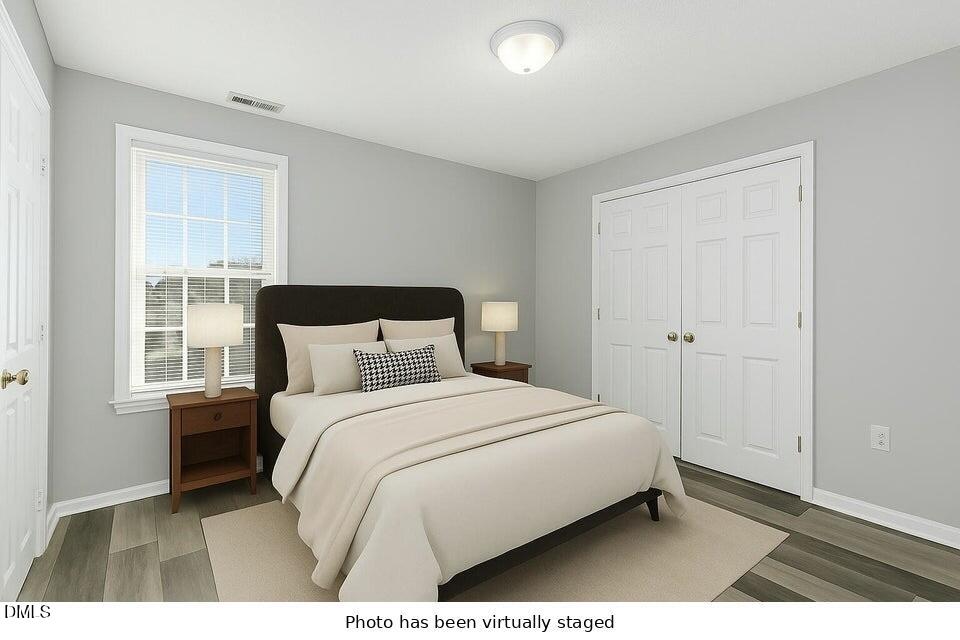 5121 Jimmy Ridge Place Raleigh, NC 27610 - Photo 15 of 18 a bedroom with a bed and window