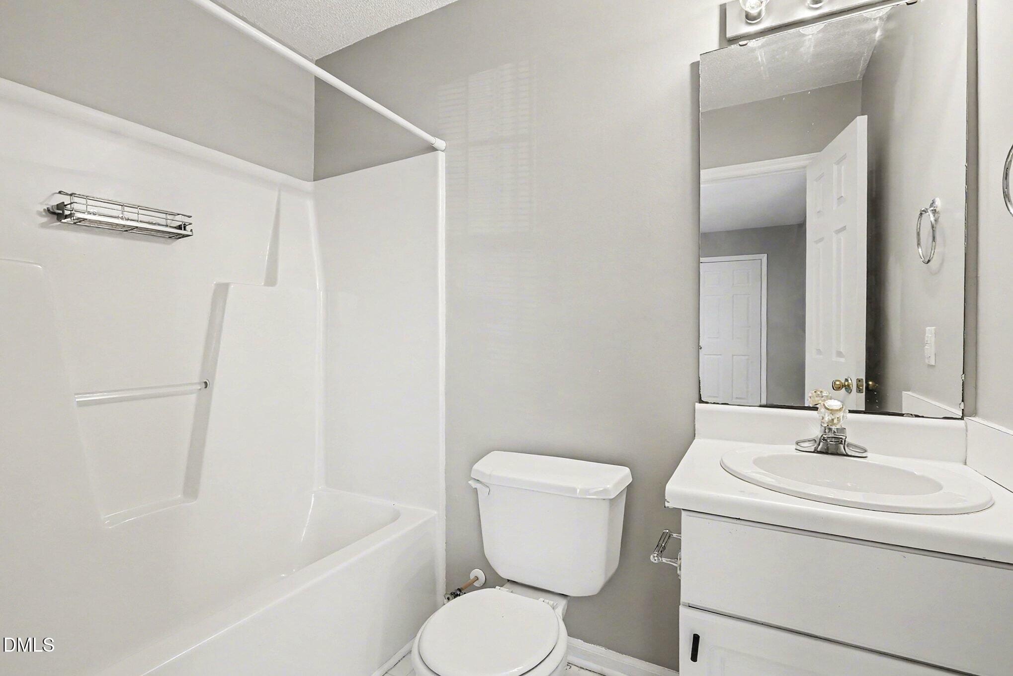 5121 Jimmy Ridge Place Raleigh, NC 27610 - Photo 16 of 18 a bathroom with a sink toilet and shower