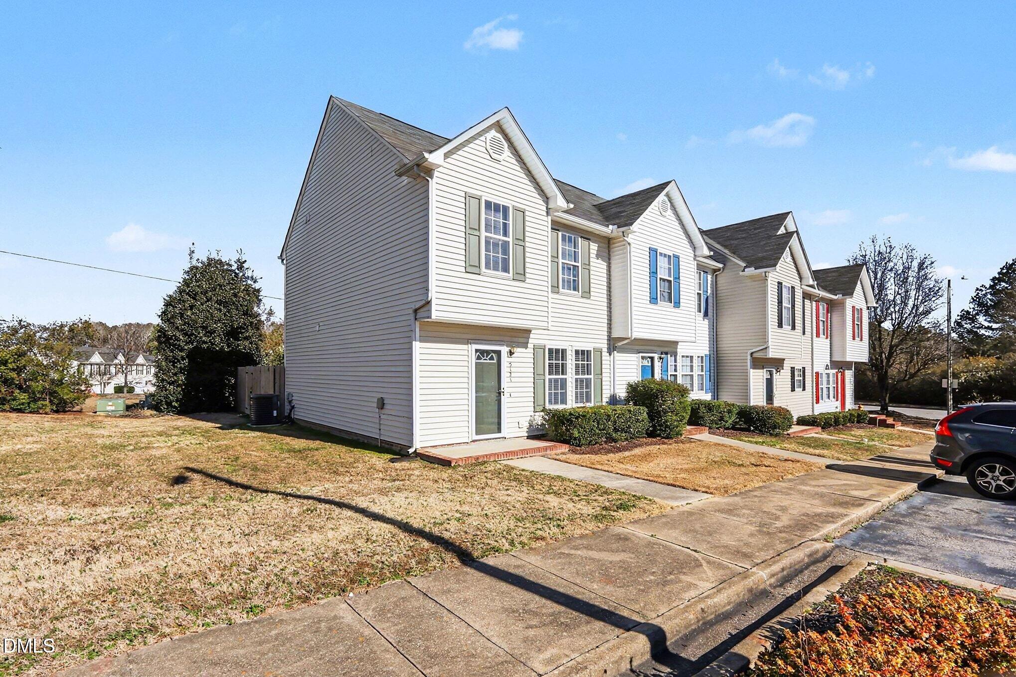 5121 Jimmy Ridge Place Raleigh, NC 27610 - Photo 2 of 18 a front view of a building with a garden