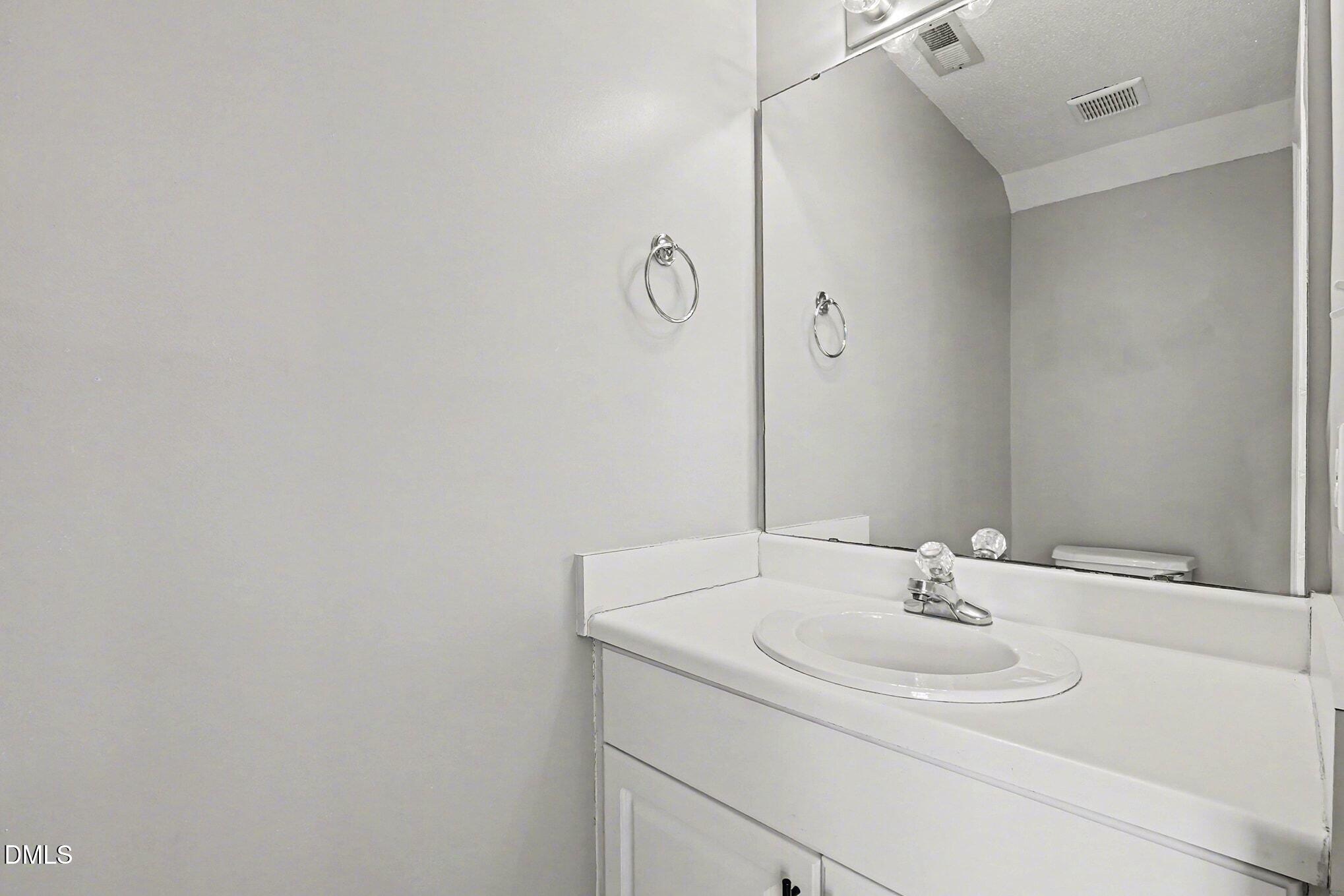 5121 Jimmy Ridge Place Raleigh, NC 27610 - Photo 6 of 18 a bathroom with a sink and a mirror