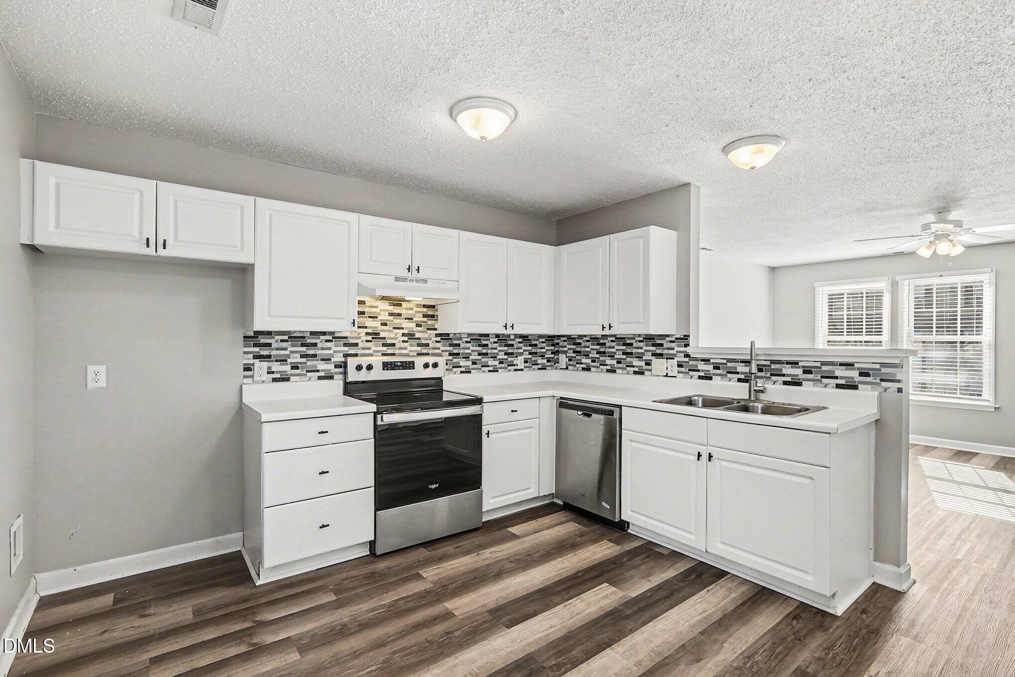 5121 Jimmy Ridge Place Raleigh, NC 27610 - Photo 7 of 18 a kitchen with granite countertop a sink and cabinets