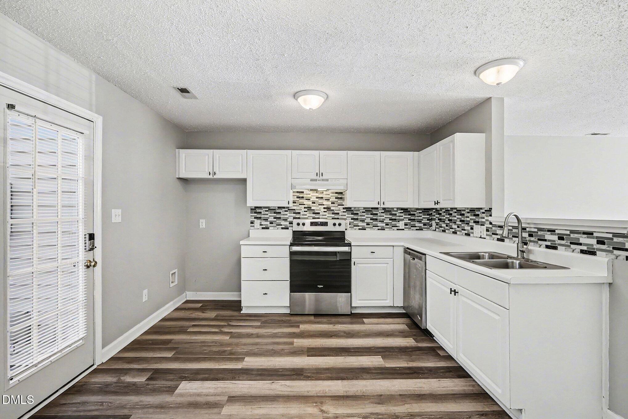 5121 Jimmy Ridge Place Raleigh, NC 27610 - Photo 8 of 18 a kitchen with sink stove and cabinets