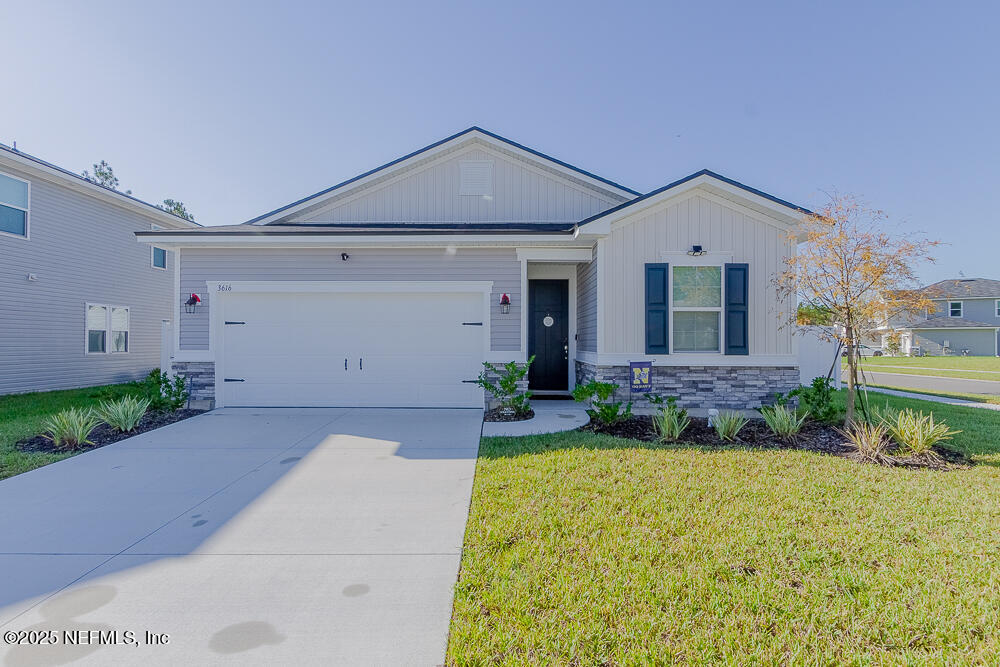 a front view of a house with a yard and garage