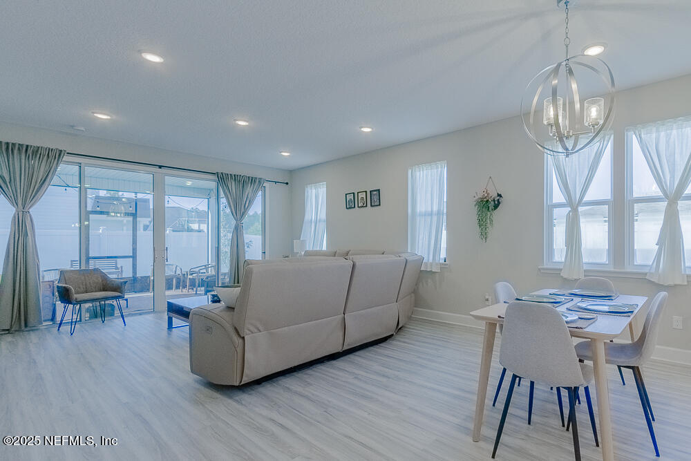3616 Cunningham Road Orange Park, FL 32065 - Photo 15 of 48 a living room with furniture and a chandelier