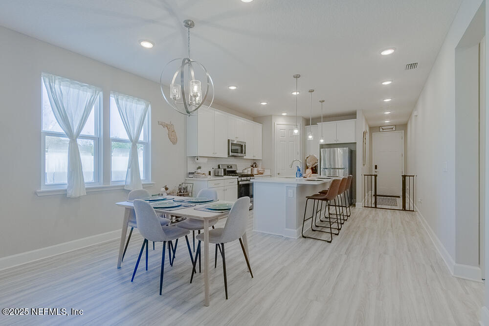 3616 Cunningham Road Orange Park, FL 32065 - Photo 16 of 48 a view of a dining room with furniture window and wooden floor