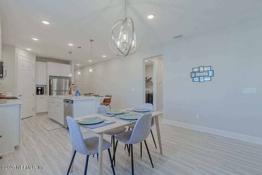 3616 Cunningham Road Orange Park, FL 32065 - Photo 17 of 48 a view of a dining room with furniture and wooden floor