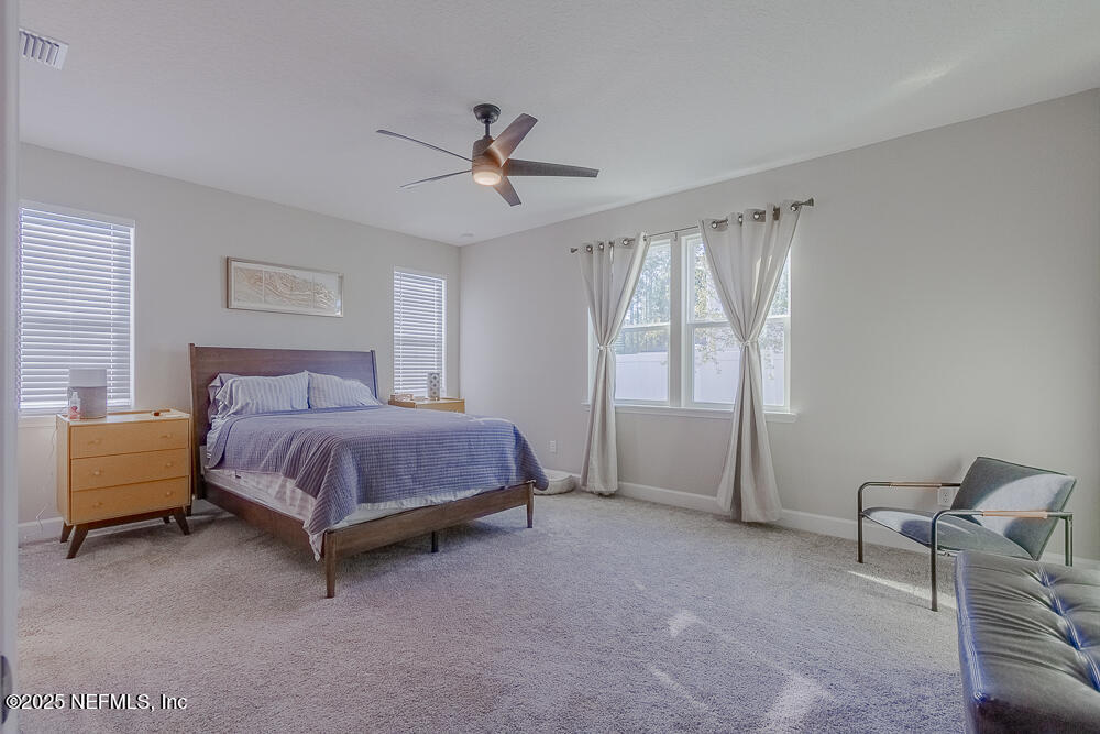 3616 Cunningham Road Orange Park, FL 32065 - Photo 22 of 48 a spacious bedroom with a bed and a window