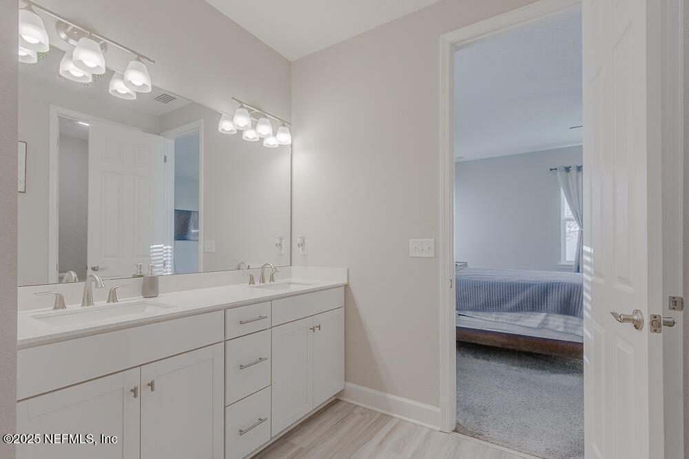 3616 Cunningham Road Orange Park, FL 32065 - Photo 23 of 48 a en suite bathroom with double sink and a mirror
