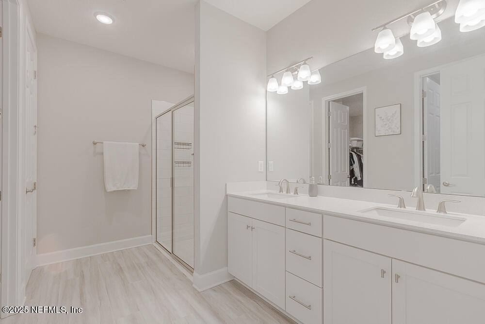 3616 Cunningham Road Orange Park, FL 32065 - Photo 24 of 48 a bathroom with a double vanity sink and a mirror