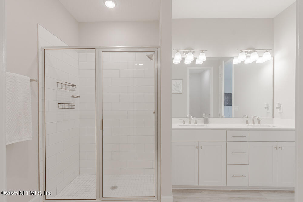 3616 Cunningham Road Orange Park, FL 32065 - Photo 25 of 48 a bathroom with a double vanity sink and a mirror