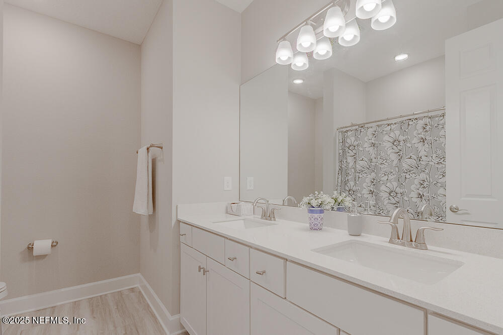 3616 Cunningham Road Orange Park, FL 32065 - Photo 28 of 48 a bathroom with a sink and a mirror