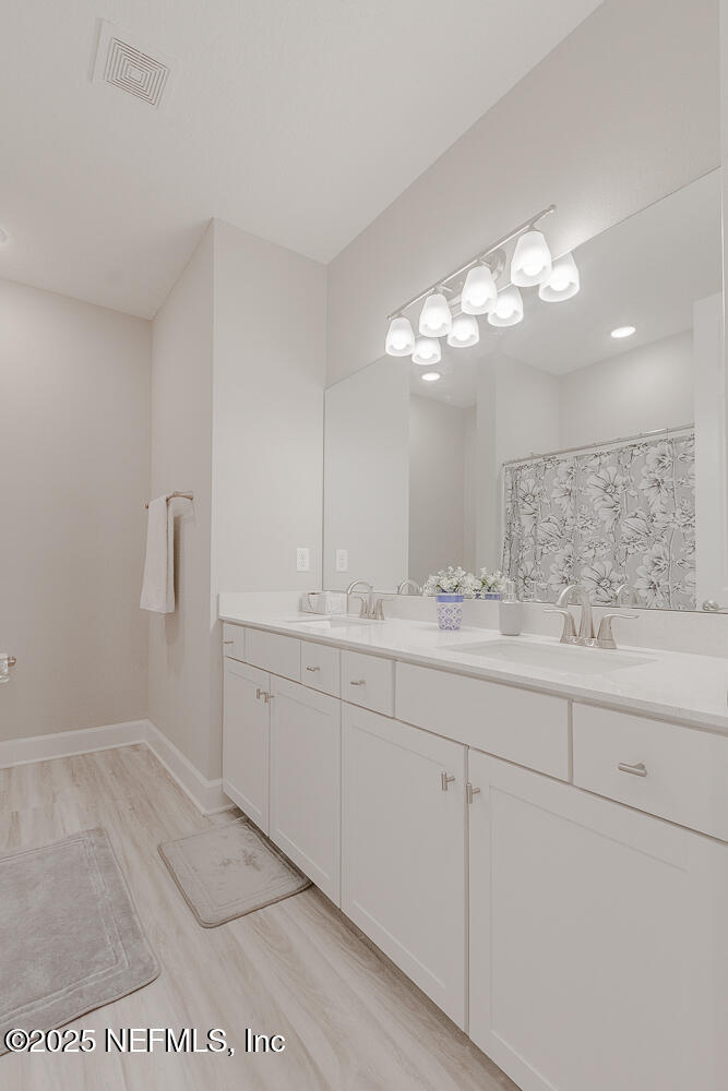 3616 Cunningham Road Orange Park, FL 32065 - Photo 29 of 48 a bathroom with a sink and a mirror