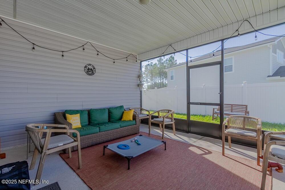 3616 Cunningham Road Orange Park, FL 32065 - Photo 42 of 48 a living room with furniture and a floor to ceiling window