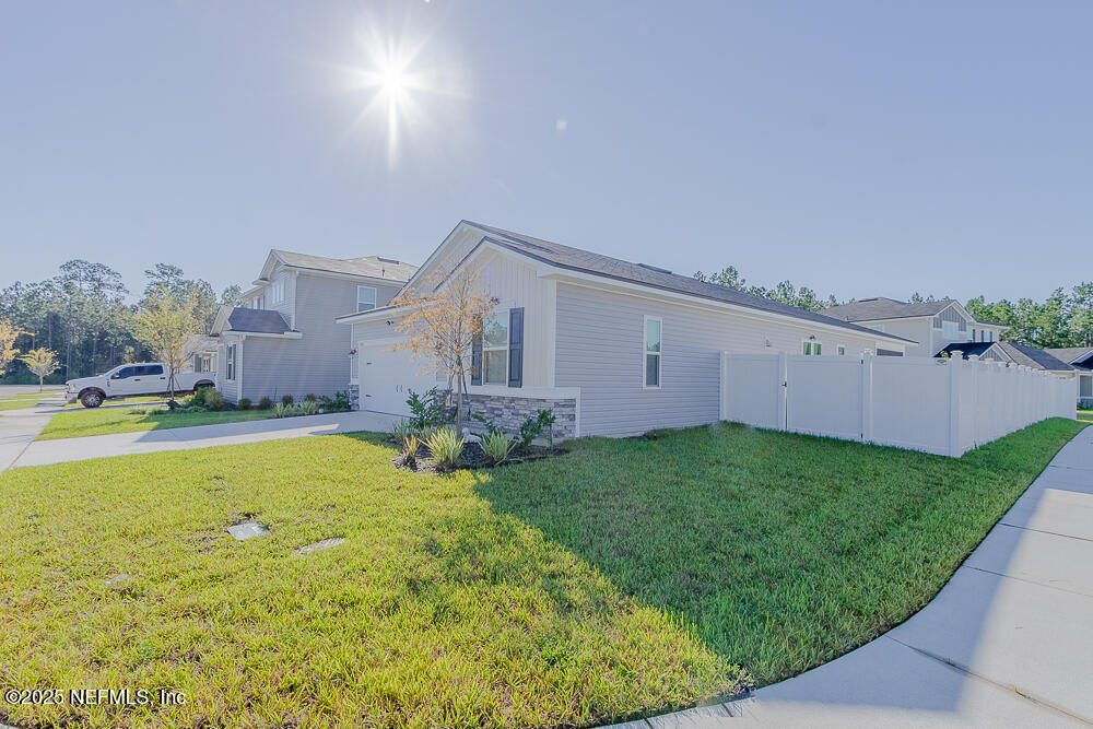 3616 Cunningham Road Orange Park, FL 32065 - Photo 44 of 48 a view of an house with backyard space and garden