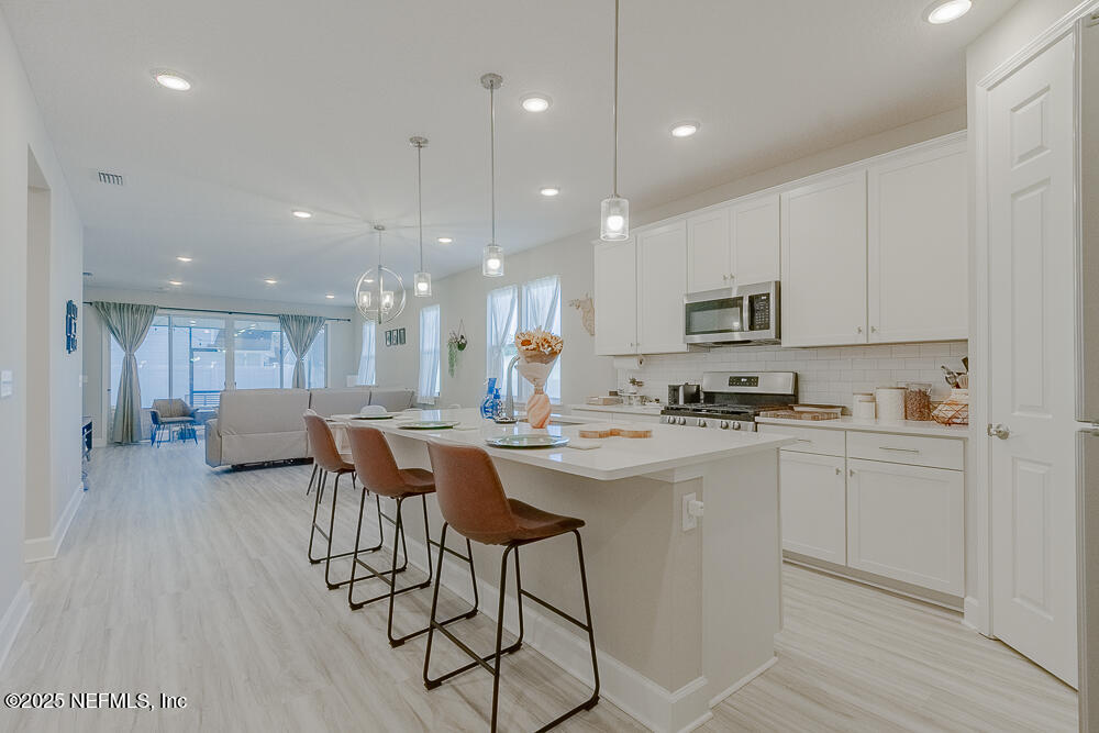 3616 Cunningham Road Orange Park, FL 32065 - Photo 7 of 48 a kitchen with counter space cabinets and appliances