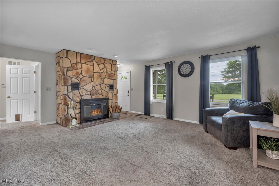 1661 Keefer Road Girard, OH 44420 - Photo 11 of 35 Living room featuring plenty of natural light, a fireplace, and baseboards