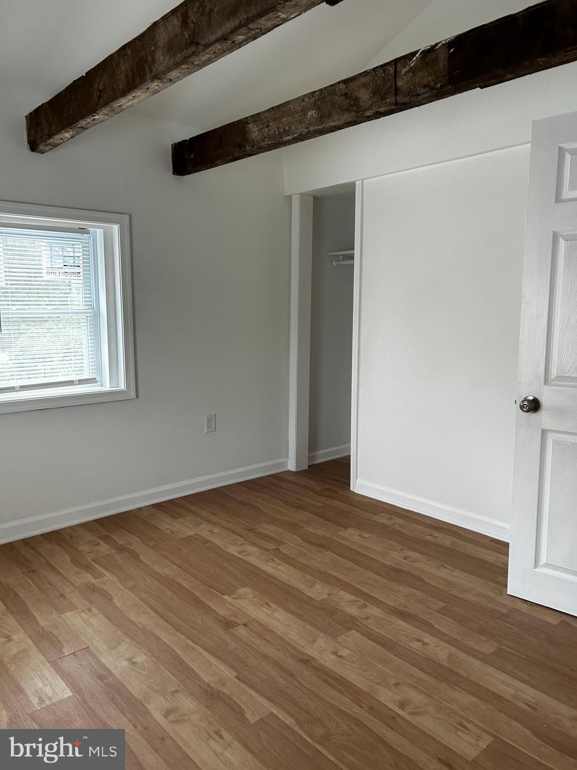114 Center Street Bridgeport, PA 19405 - Photo 12 of 16 a view of an empty room with wooden floor and a window