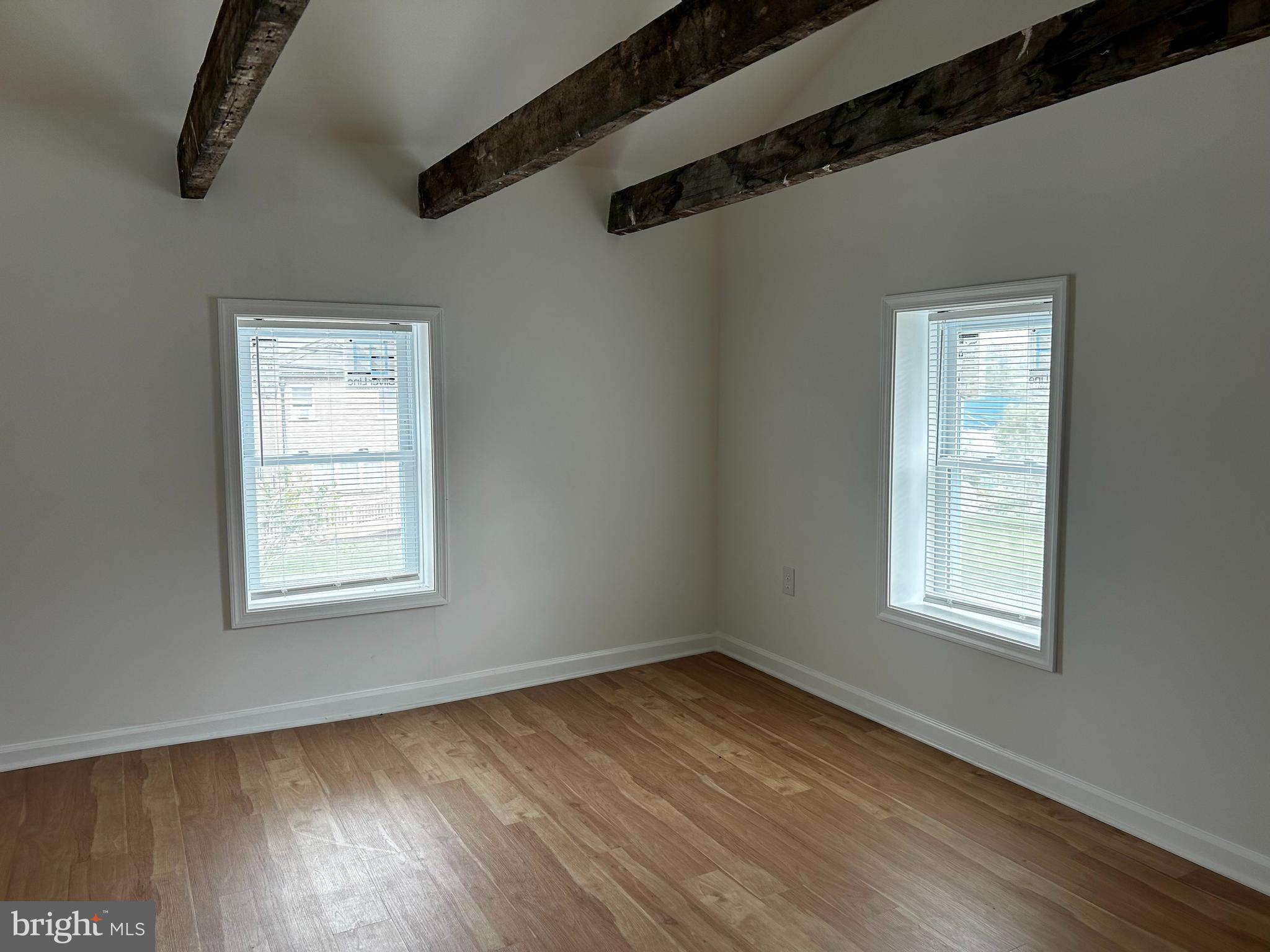 114 Center Street Bridgeport, PA 19405 - Photo 13 of 16 an empty room with wooden floor and windows
