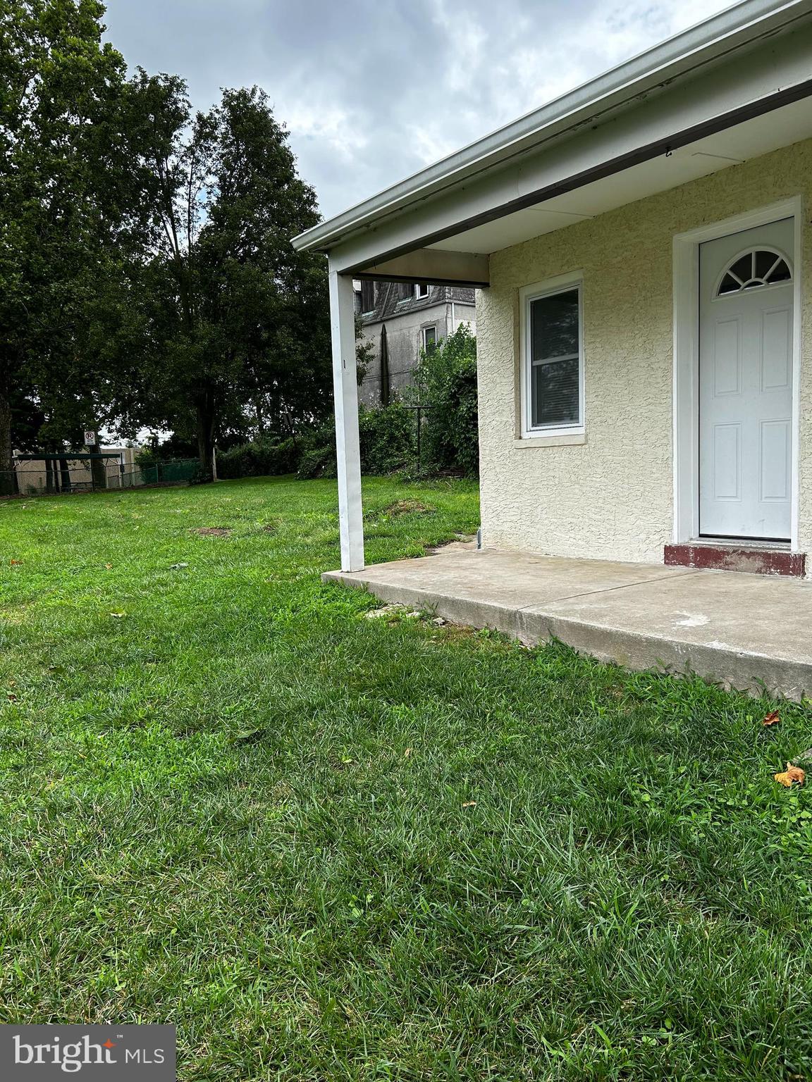 114 Center Street Bridgeport, PA 19405 - Photo 4 of 16 a view of a house with backyard and trees