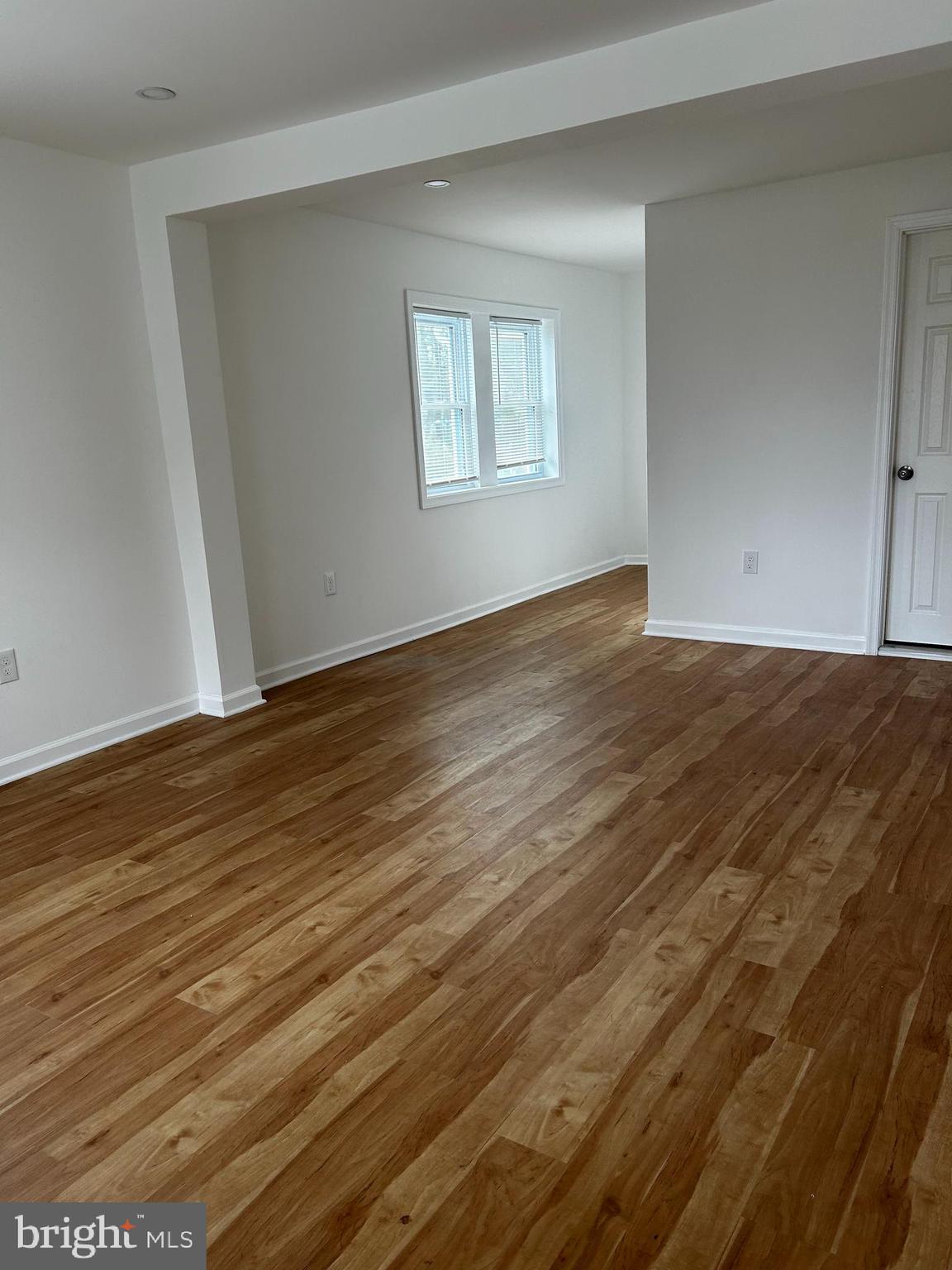 114 Center Street Bridgeport, PA 19405 - Photo 6 of 16 a view of an empty room with wooden floor and a window