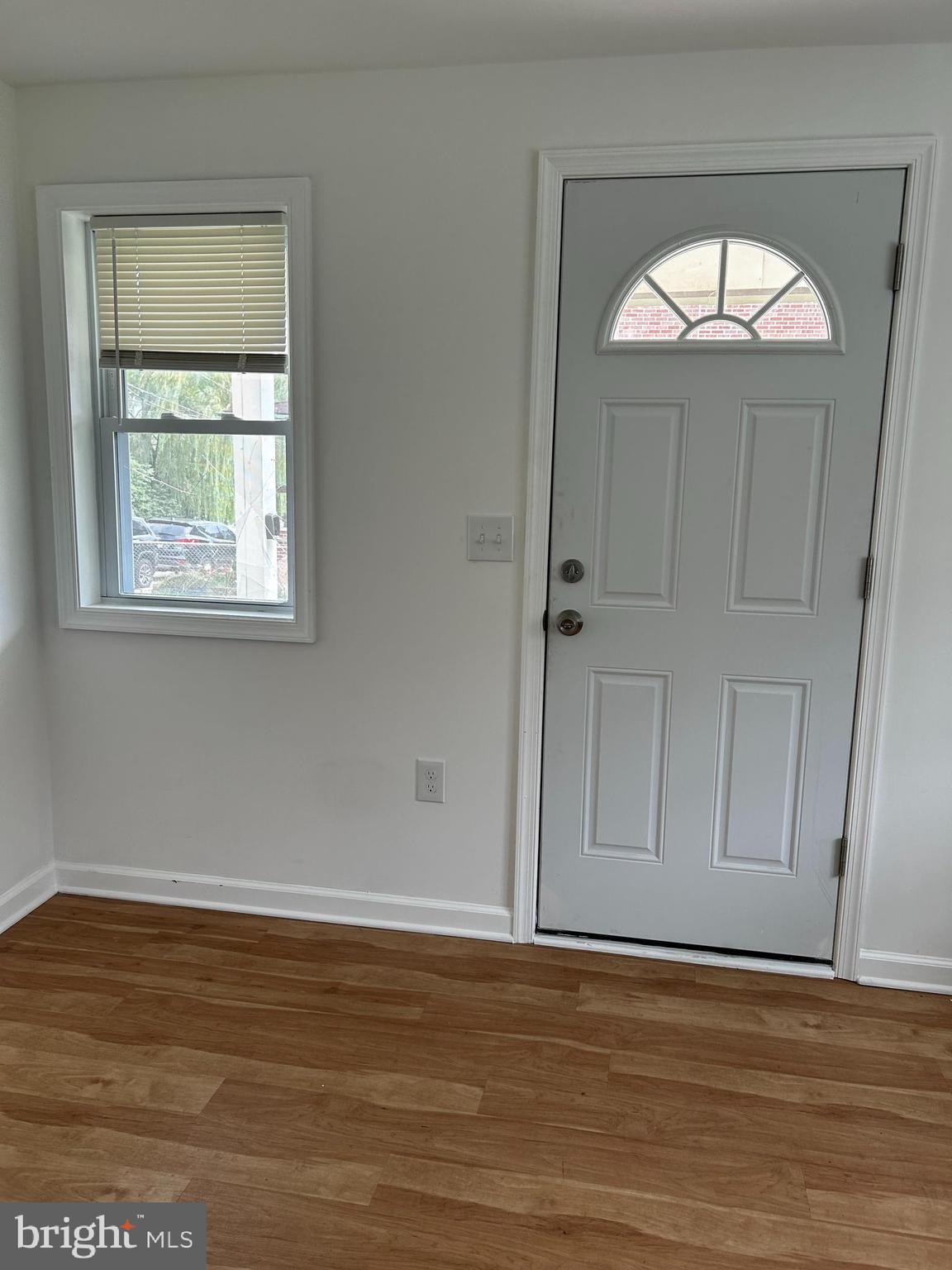 114 Center Street Bridgeport, PA 19405 - Photo 7 of 16 a view of empty room with window and wooden floor