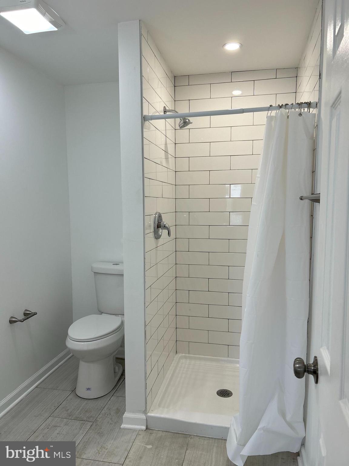 114 Center Street Bridgeport, PA 19405 - Photo 8 of 16 a bathroom with a shower and a toilet