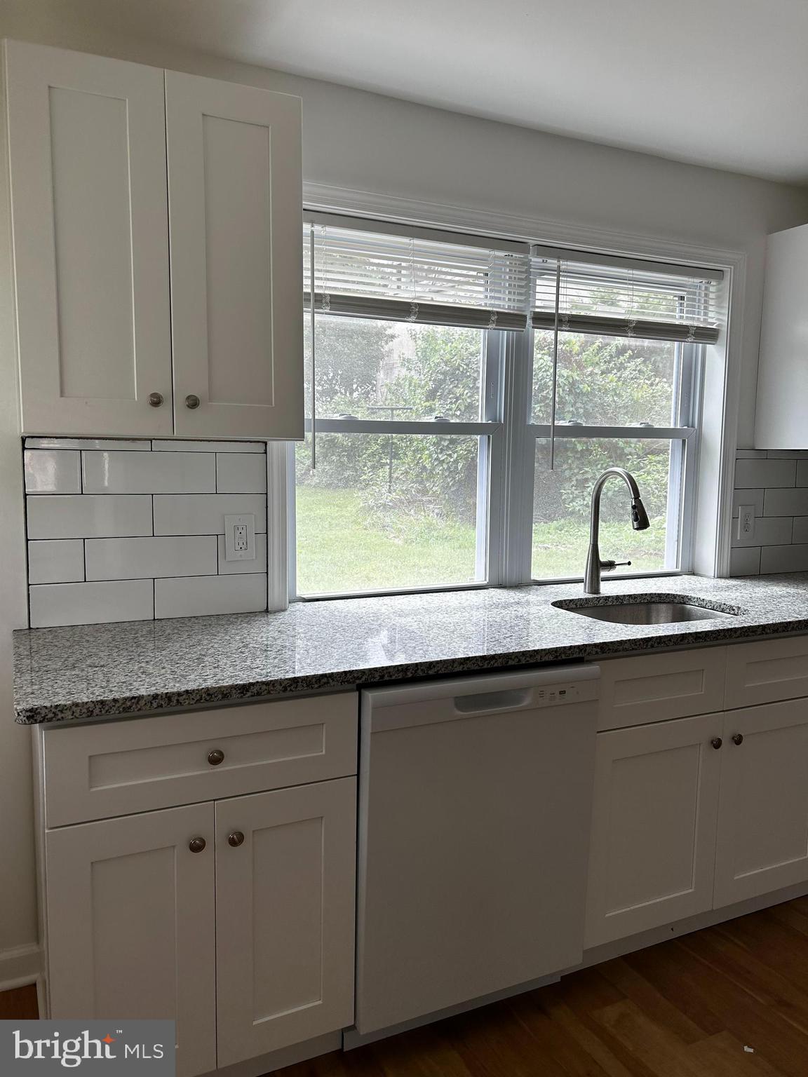114 Center Street Bridgeport, PA 19405 - Photo 10 of 16 a kitchen with granite countertop white cabinets and a window