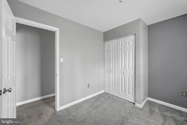 a view of an empty room with closet area