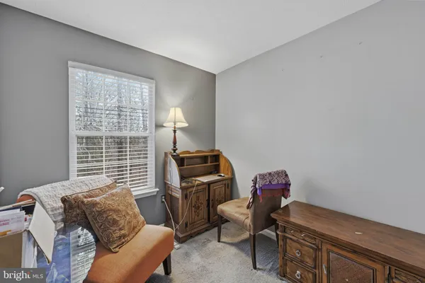 a livingroom with workspace and a window