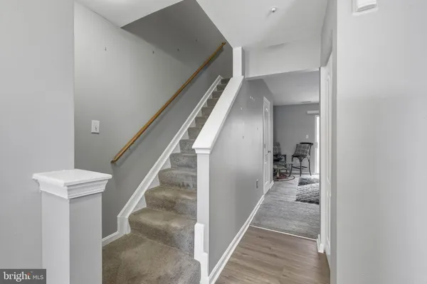 a view of a hallway with wooden floor and entryway