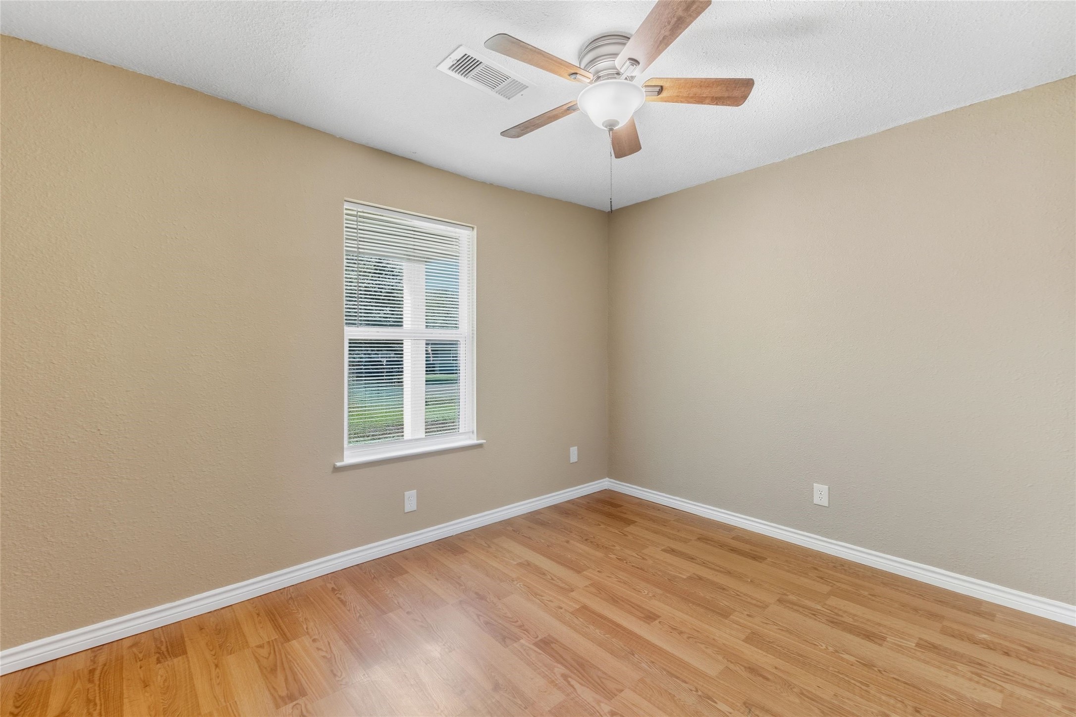 340 Warner Street Bridge City, TX 77611 - Photo 11 of 15 an empty room with a window and a fan