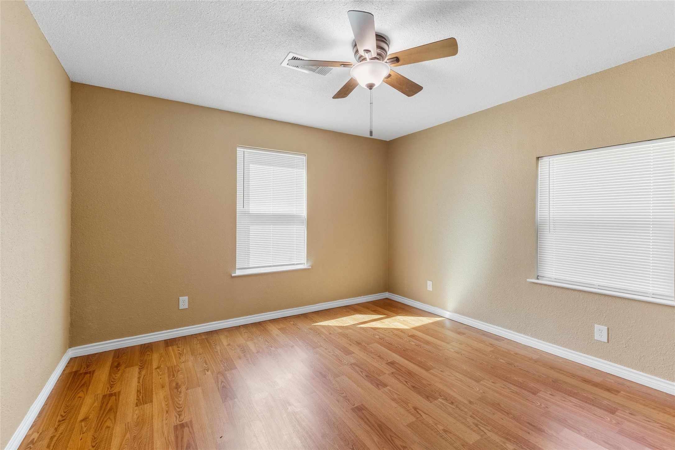 340 Warner Street Bridge City, TX 77611 - Photo 13 of 15 an empty room with a window and a ceiling fan