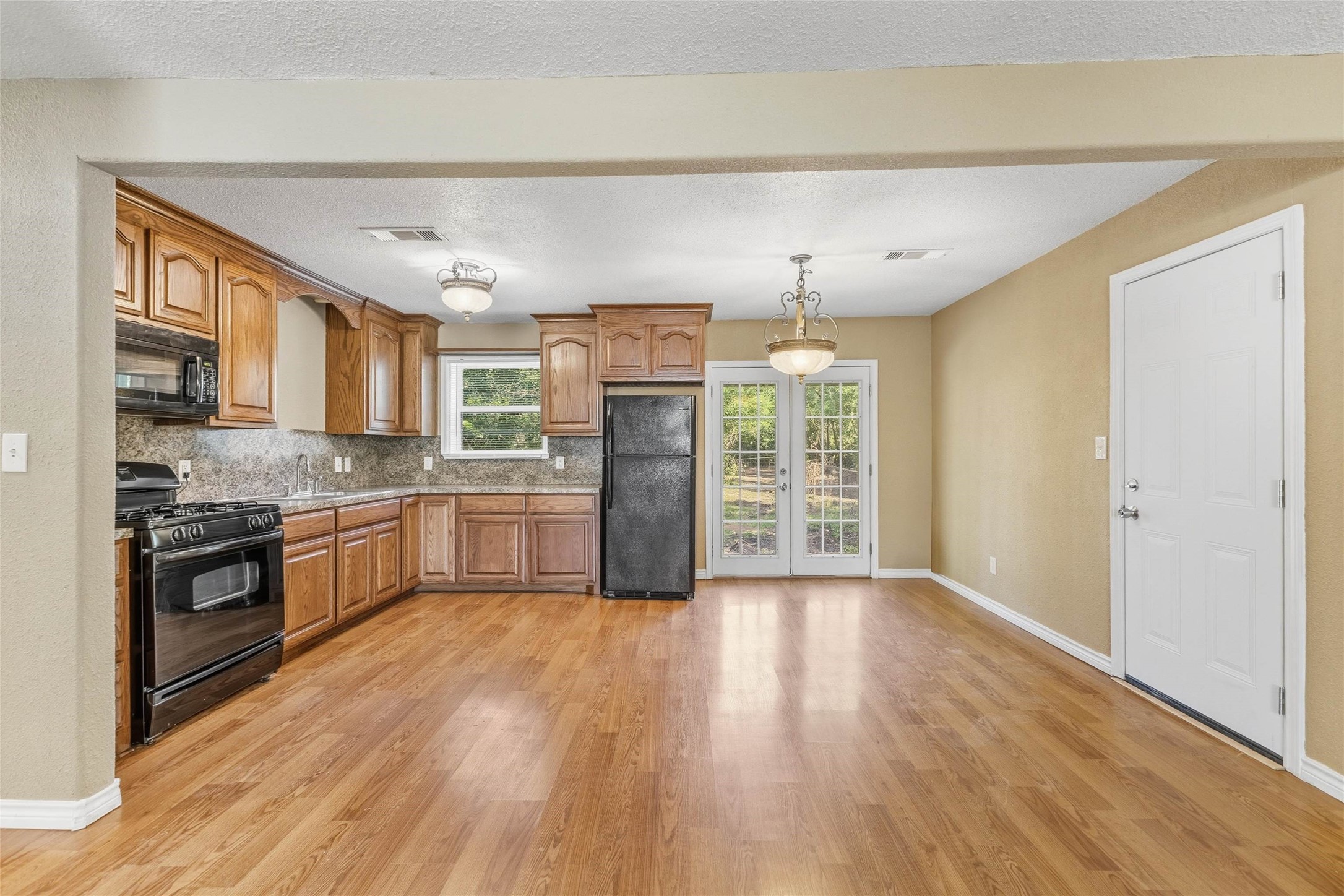 340 Warner Street Bridge City, TX 77611 - Photo 5 of 15 a large kitchen with stainless steel appliances granite countertop a lot of counter space and wooden floors