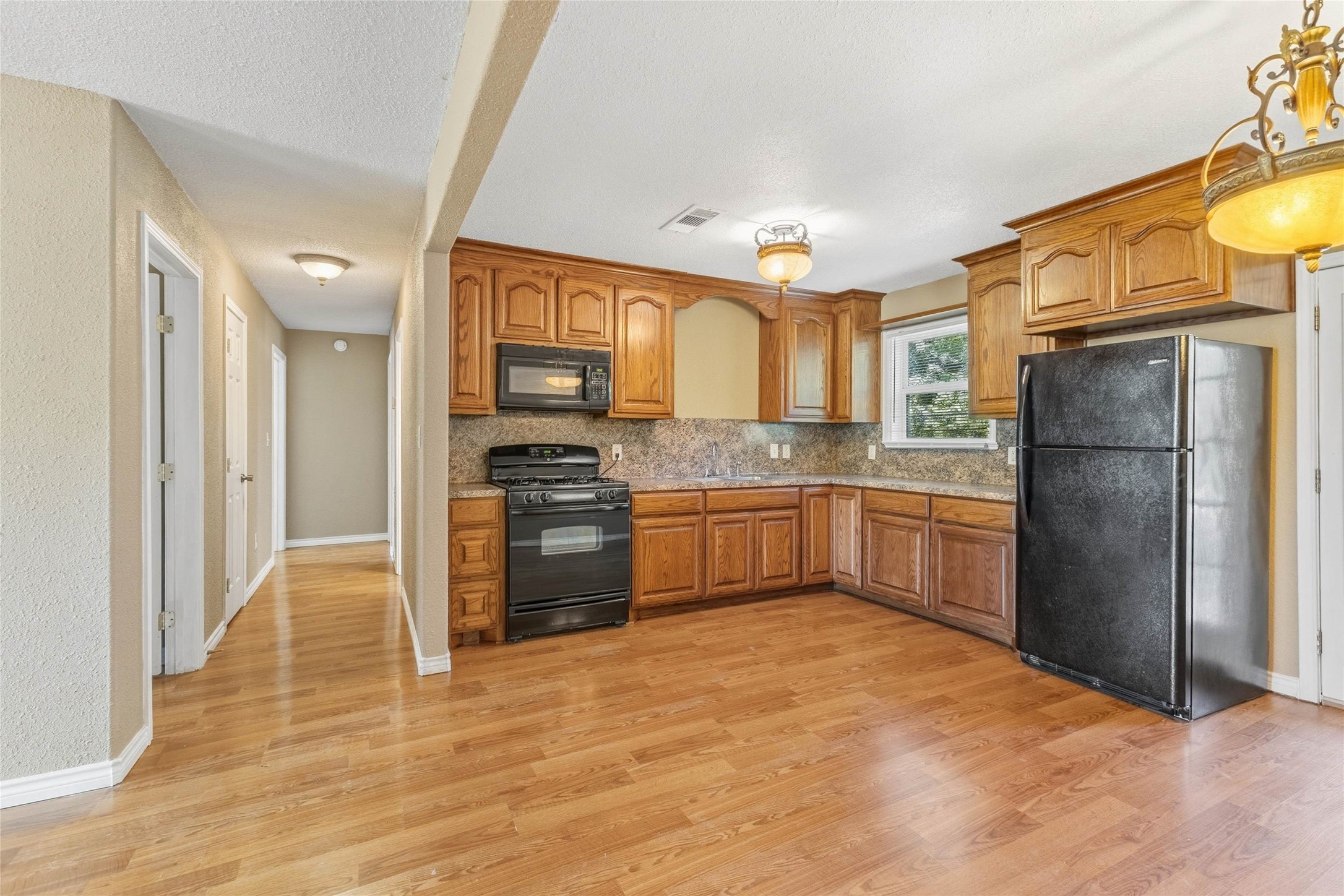 340 Warner Street Bridge City, TX 77611 - Photo 6 of 15 a kitchen with a refrigerator and a sink