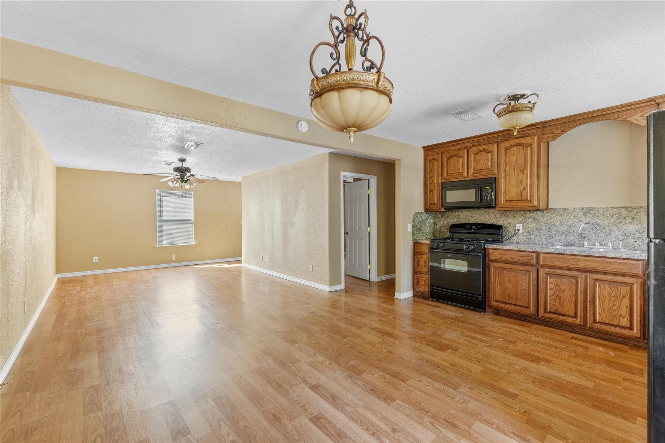340 Warner Street Bridge City, TX 77611 - Photo 7 of 15 a kitchen with granite countertop a stove a sink and a refrigerator