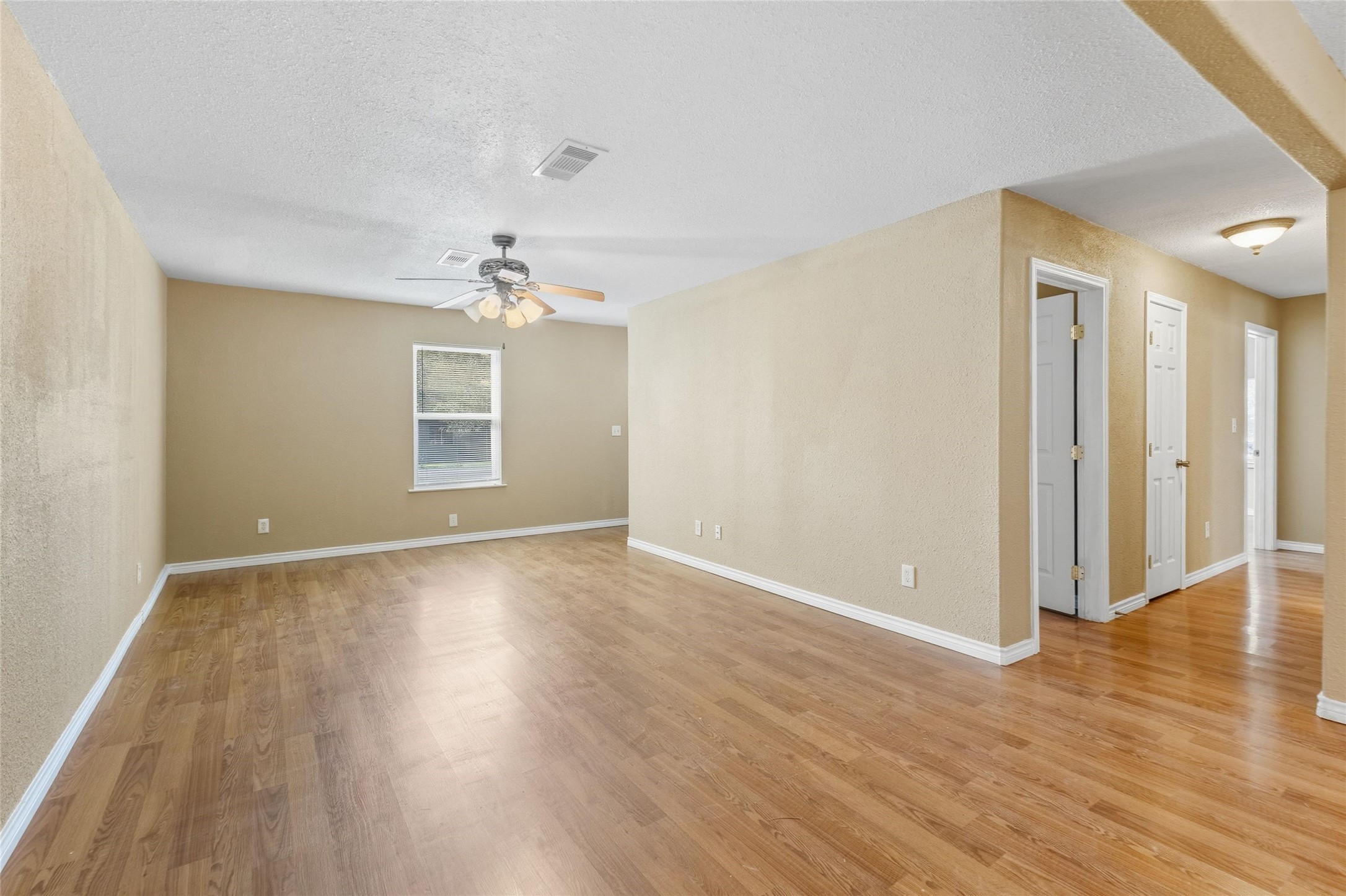 340 Warner Street Bridge City, TX 77611 - Photo 8 of 15 wooden floor in an empty room with a window