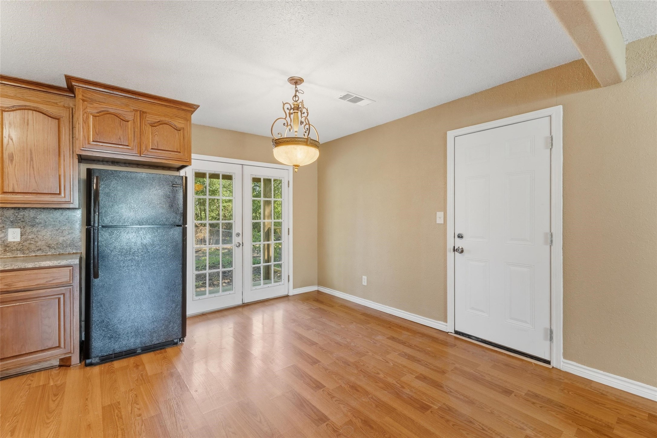 340 Warner Street Bridge City, TX 77611 - Photo 9 of 15 an empty room with wooden floor cabinet and windows