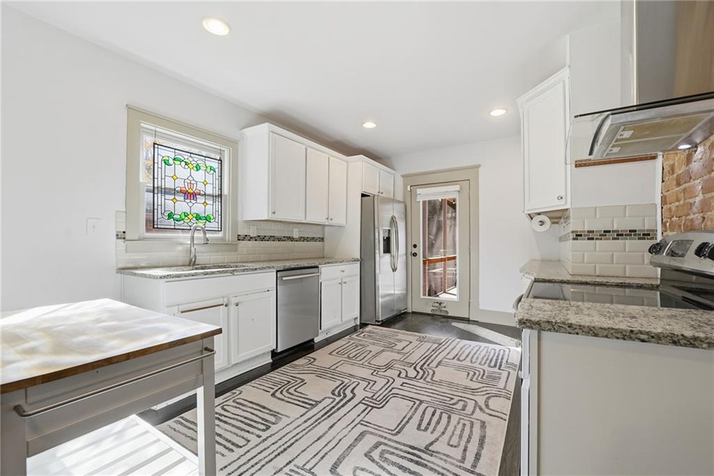 1530 South Gordon Street Southwest Atlanta, GA 30310 - Photo 17 of 46 a kitchen with a sink stove and refrigerator