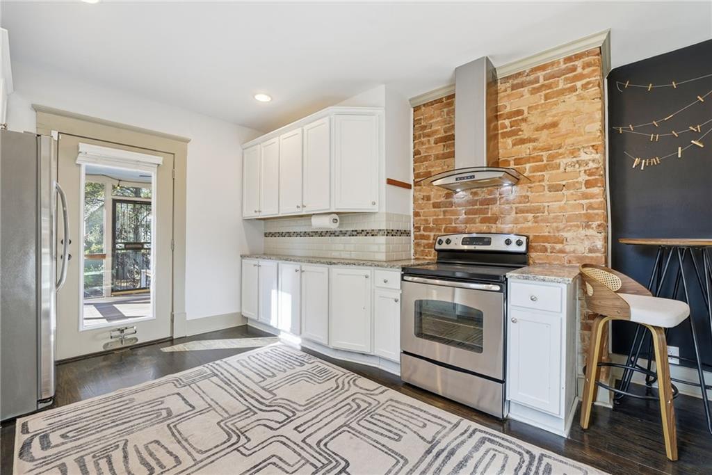 1530 South Gordon Street Southwest Atlanta, GA 30310 - Photo 22 of 46 a kitchen with stainless steel appliances granite countertop a stove a sink and a microwave