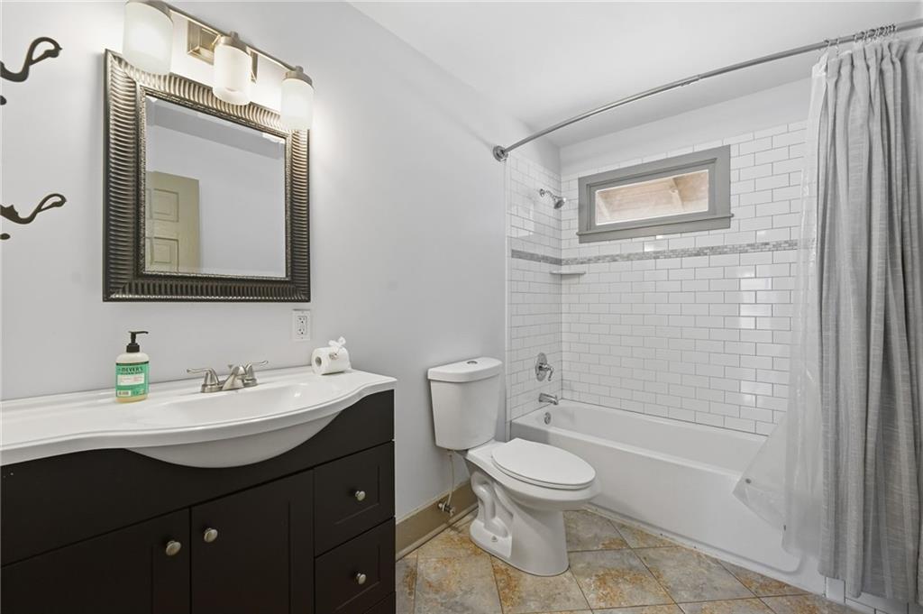 1530 South Gordon Street Southwest Atlanta, GA 30310 - Photo 36 of 46 a bathroom with a toilet sink vanity and mirror