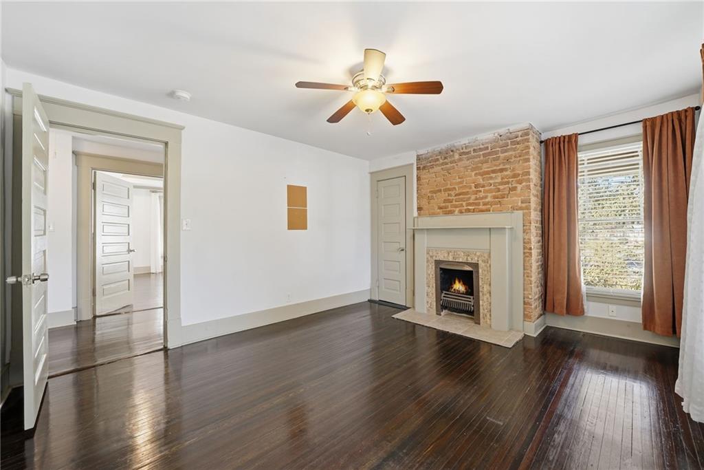1530 South Gordon Street Southwest Atlanta, GA 30310 - Photo 38 of 46 a view of a livingroom with wooden floor a ceiling fan and a window