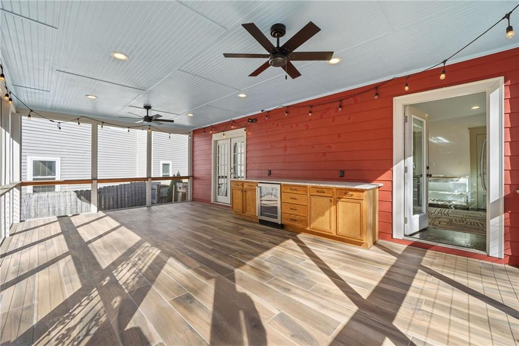 1530 South Gordon Street Southwest Atlanta, GA 30310 - Photo 40 of 46 a spacious bedroom with a bed a dresser and a chandelier