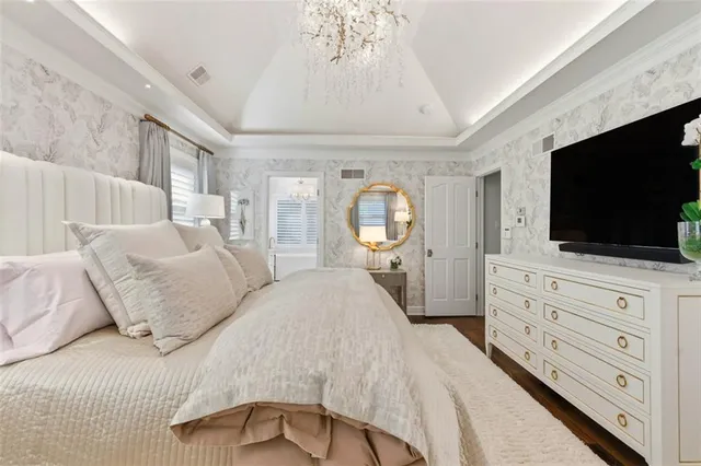 a spacious bathroom with a double vanity sink a mirror a bathtub and next to a window