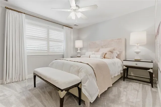 a spacious bedroom with a bed and a chandelier