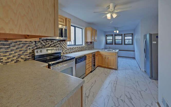 390 Colony Cove Alpharetta, GA 30022 - Photo 2 of 41 a kitchen with stainless steel appliances granite countertop a stove a sink and a refrigerator